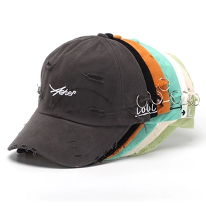 Detailed stack of distressed cotton baseball caps with letter embroidery in multiple colors