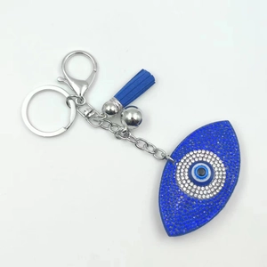 Sparkling rhinestone evil eye keychain with blue tassel and crystal-encrusted charm