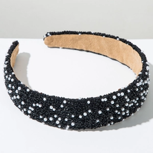 Close-up of wide headband with black faceted beads, white pearls, and non-slip inner lining