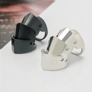 Articulated metal armor knuckle ring in black and silver shown from a side view angle