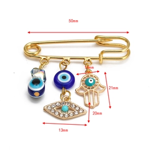 Detailed dimensions of Hamsa Hand and Evil Eye charms on a 50mm gold safety pin