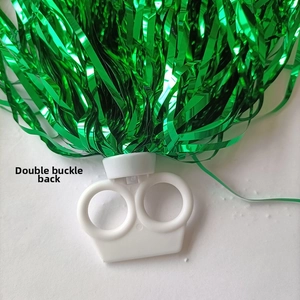 Detailed back view of double-ring handle on green metallic cheerleading pom pom