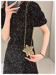 Fashionable gold star-shaped crossbody bag featuring intricate hollow grid pattern details