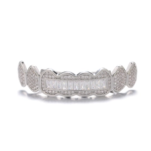 Macro shot of silver hip-hop grillz featuring rectangular and round iced-out diamonds