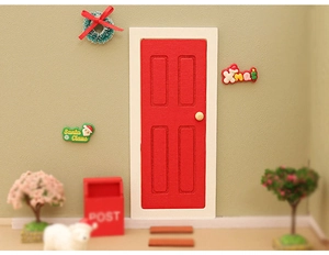Miniature dollhouse Christmas decor set featuring a red door, wreaths and Xmas signs