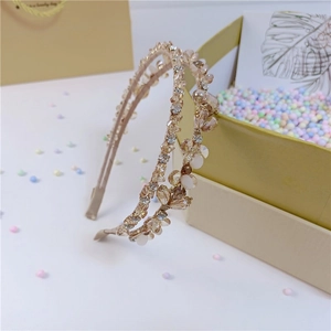 Detail of luxury crystal headbands with champagne rhinestones and pearlescent accents