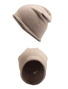 Close-up of beige rabbit fur beanie showing detailed knit texture and wash label