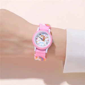 Close-up of pink unicorn cartoon watch showing the soft silicone strap on wrist