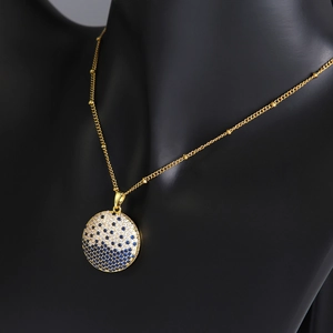 Elegant gold beaded necklace with a round blue and white crystal planet pendant for women