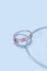 Macro shot of silver stackable ring featuring colorful baguette zircons and beaded edge details