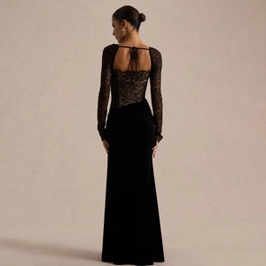 Elegant black evening gown featuring lace sleeves and open back with velvet split skirt