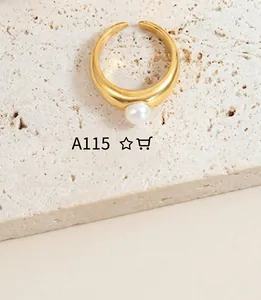 Detailed macro shot of a gold-finish open ring featuring a lustrous white pearl accent