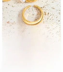 Detailed macro shot of a gold-finish open ring featuring a lustrous white pearl accent