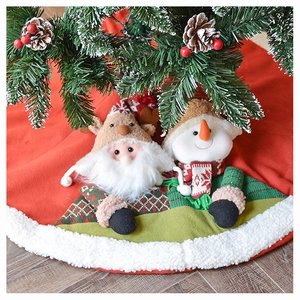 Detail of red knitted Christmas tree skirt with plush 3D Santa and Snowman figures