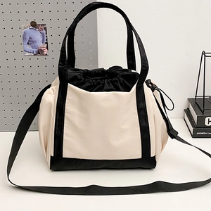 Versatile beige and black star logo tote bag with drawstring closure and shoulder strap