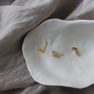 Detailed macro view of 18K gold-plated honeycomb earrings with tiny cubic zirconia insets