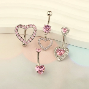 Pink heart zircon navel rings set with silver metal base on white display steps