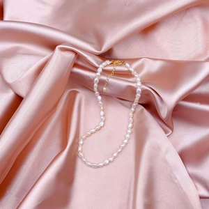 Natural baroque freshwater pearl necklace with 14k gold-filled clasp on pink silk