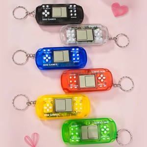 Mini Tetris game console keychains in six assorted colors on a soft pink background