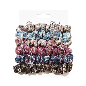 6-piece set of floral fabric scrunchies in assorted colors on display card for hair styling
