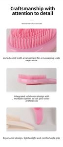 Detail of pink detangling massage brush featuring ergonomic handle and flexible soft bristles
