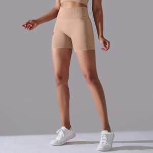 Detail of light brown high-waisted seamless ribbed workout shorts for yoga and fitness