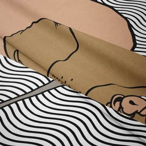 Detail showing soft flannel fabric texture and cartoon monkey print with wave patterns