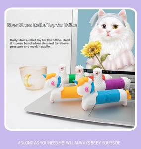 Detail of colorful unicorn pop tube fidget toys on a desk with a laptop background