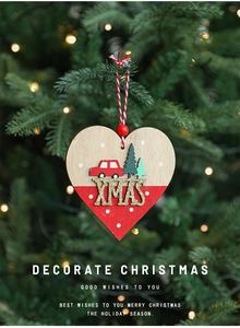 Detail of a red and natural wooden heart ornament with XMAS car decor on a Christmas tree