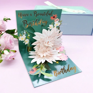 Detail of 3D pop-up birthday card with layered white pink paper flowers and gold lettering