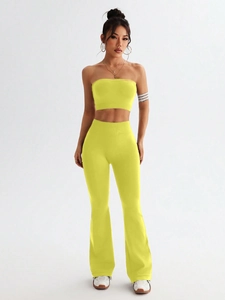 Detail view of fluorescent green seamless two-piece yoga set with flared pants and crop top