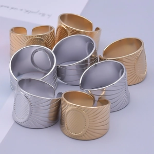 Detailed close-up of gold and silver open rings with radial patterns and oval centers
