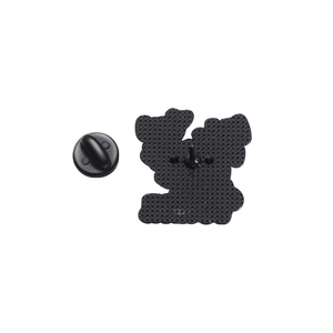 Detail view of the black metal brooch back with needle and rubber clutch closure