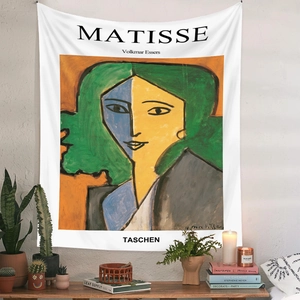 Close-up of Henri Matisse art tapestry in a cozy room with cactus and candle decor
