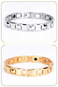 Detail of link bracelets in silver and gold tones with embedded germanium stones