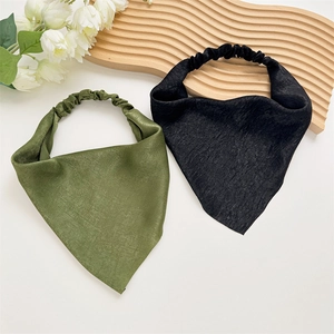 Detailed view of satin triangle hair scarves in olive green and black with elastic bands