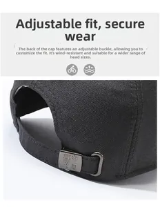 Detail of black baseball cap featuring adjustable metal buckle with decorative engraving