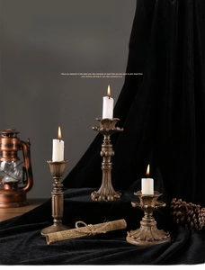 Detailed view of vintage bronze lotus carved candlesticks on black velvet