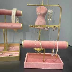 Golden metal jewelry display stand with luxury pearl necklaces, rings and hairbands