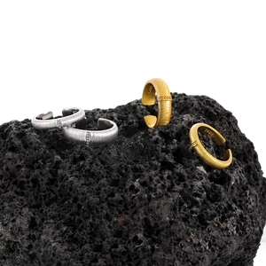 Brushed S925 sterling silver open rings in gold and silver finish on volcanic stone
