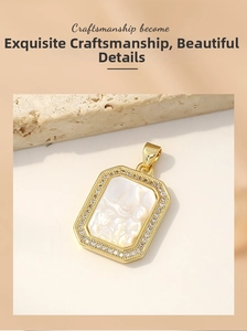 Macro detail of gold plated mother of pearl Virgin Mary pendant with CZ inlay border
