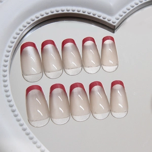Elegant cat eye French red tip press-on nails in long coffin shape on a heart mirror tray
