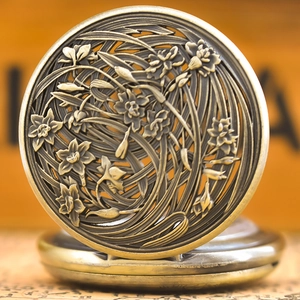 Detailed macro view of vintage bronze pocket watch with hollow floral carving