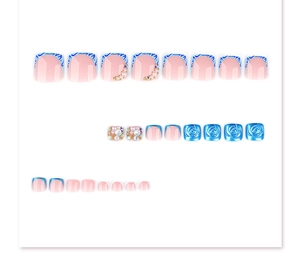 Detailed view of press-on toenails featuring 3D blue roses, pearls, and rhinestones
