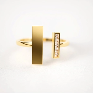 Detailed view of an open gold ring featuring asymmetric bars and five inlaid zircon stones