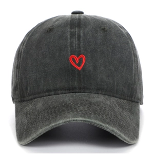 Vista frontale di un cappello da baseball nero lavato con ricamo di un piccolo cuore rosso.