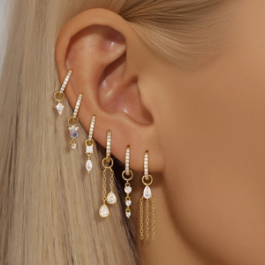 Detailed view of six gold-plated S925 silver earrings with sparkling cubic zirconia stones