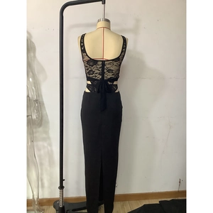 Detail of elegant black lace maxi dress showing open back design and rose patterns