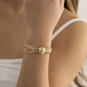 Detailed view of multilayer gold mesh chain bracelet with a polished sphere bead