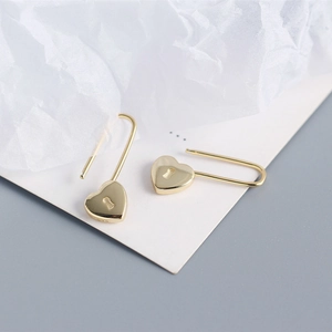 Detail showing S925 hallmark on gold heart-shaped lock earrings made of sterling silver